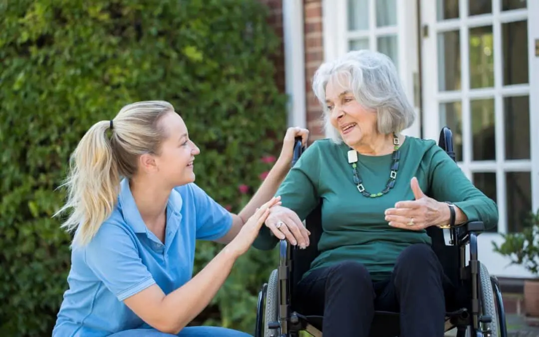 An elderly woman being cared for by a nurse at home